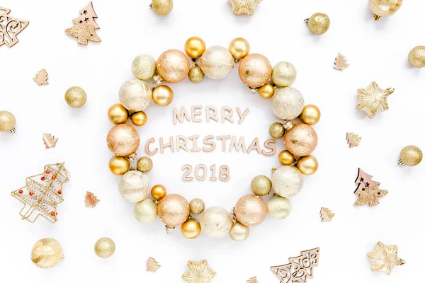 Holiday round frame, pattern made and gold glass Christmas balls, golden toys isolated on a white background. Merry Christmas. Flat lay, top view