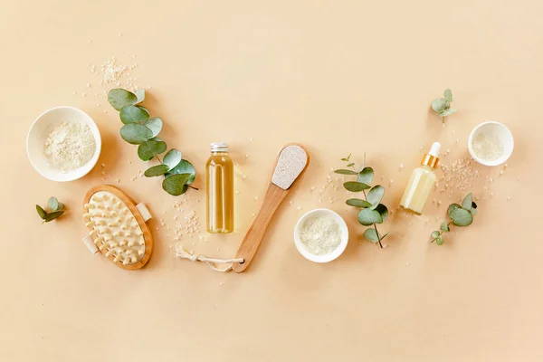 Spa treatment concept. Natural, Organic spa cosmetics products with eucalyptus oil, sea salt, massage brush, eucalyptus leaf extract. Spa background