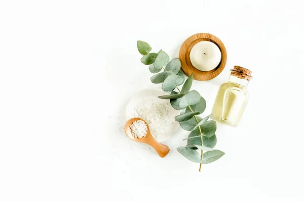 Bottle of eucalyptus essential oil, eucalyptus leaves on white background. Natural Organic cosmetics products. Flat lay, top view. — Stock Photo, Image