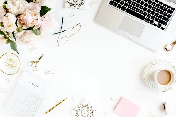 Flat lay womens office desk. Female workspace with laptop, pink peonies bouquet, accessories on white background. Top view feminine background. — Stock Photo, Image