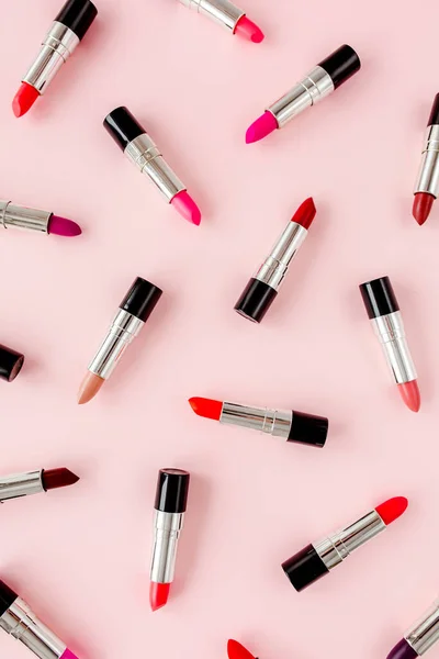 Set of color lipsticks on pink background. Professional decorative cosmetics, product pomade. Flat composition beauty, fashion. flat lay, top view