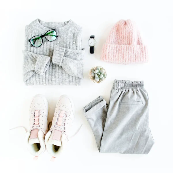 Women fashion clothes and accessories. Feminine youth top view. Flat lay female style look with warm sweater, pants, cap, sneakers, glasses. Top view. — Stock Photo, Image