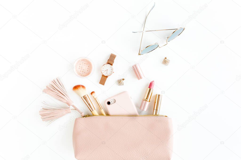 Flat lay composition with pink cosmetic bag with cosmetic makeup products, isolated on white background. Flat lay, top view.