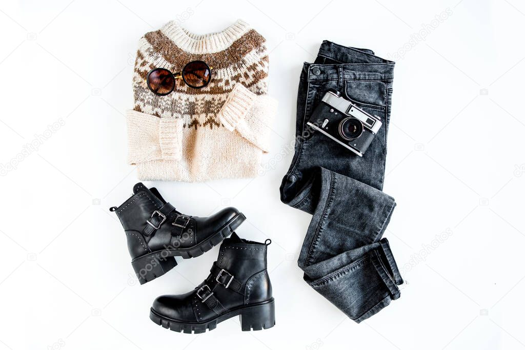 Women fashion clothes and accessories. Feminine youth collage top view. Flat lay female style look with warm sweater, jeans, boot. Top view.