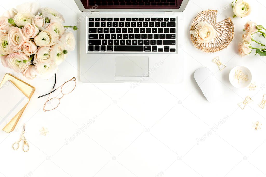 Stylized womens home office desk. Workspace with laptop, computer, bouquet ranunculus and roses, clipboard on white background. Flat lay. Top view.