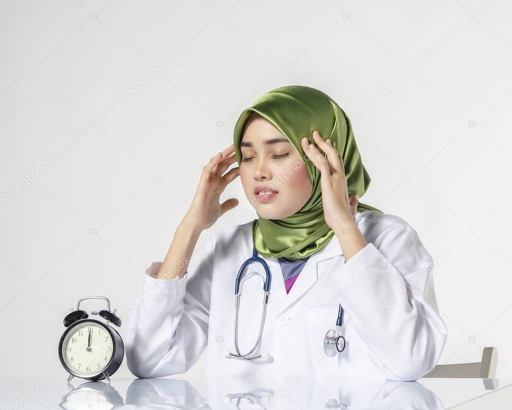 Young depressed hijab woman healthcare practitioner holding face in despair expressing her stress and tired with work concept.