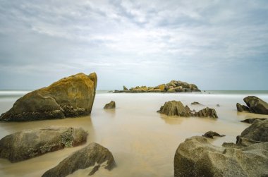 Tropikal Beach muhteşem deniz manzaralı. Islak rock ve berrak deniz suyu bulutlu gökyüzü background.blurred ve yumuşak odak resim nedeniyle uzun pozlama vurdu