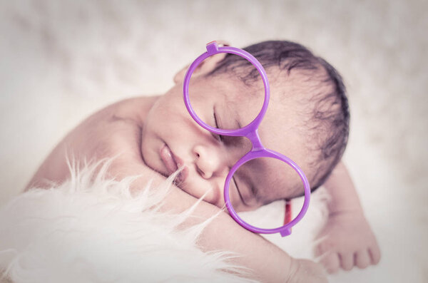 Close-up shot,cute and adorable newborn baby with costume sleeping.New life and parenting concept.