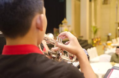 Kırpılmış ve backview görüntü, Sahne Alanı'ndaki bir orkestra ile çocuk oyun trompet