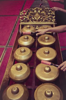 Malaysian traditional music instrument called Gamelan with beautiful wood carving frame. selective focus shot clipart