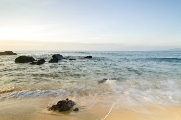 Seyahat ve tatil kavramı arka plan, güzel tropikal plaj gündoğumu deniz manzarası. Dalga yumuşak isabet kumlu plaj