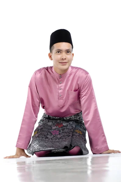 Handsome asian man with traditional clothing during hari raya over white background — Stock Photo, Image