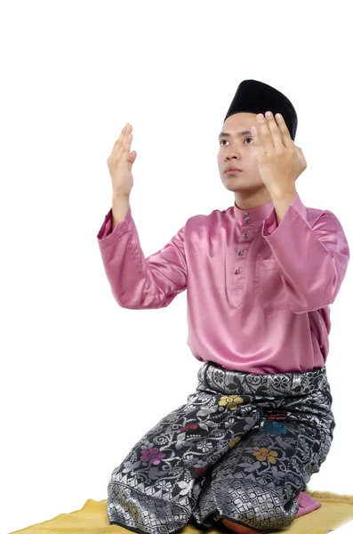 Jovem e bonito asiático homem com tradicional roupas levantando mão para rezar sobre branco fundo — Fotografia de Stock