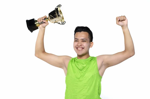 Happy ekspresi pemuda fit pria dalam pakaian olahraga, memegang piala emas atas latar belakang putih — Stok Foto