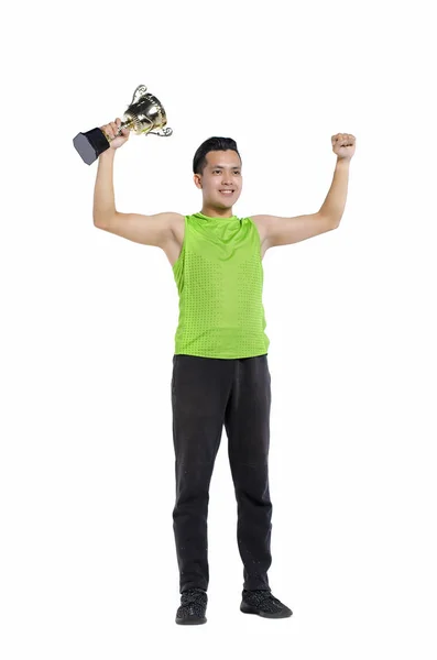 Sportruházat, állandó, és a gazdaság arany trófeát, fehér háttérhez képest fit fiatalember portréja, teljes test hossza — Stock Fotó