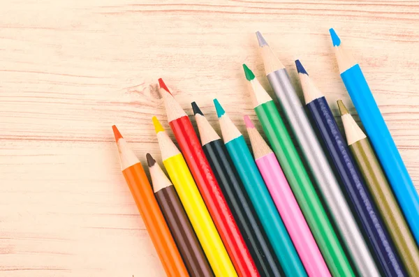 Close-up image of Colourful pencils on wooden desk — Stock Photo, Image