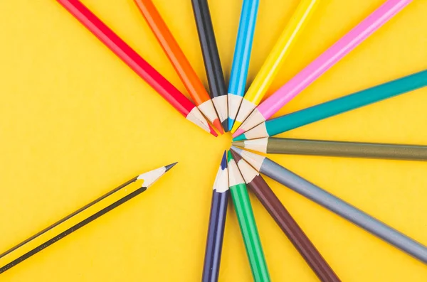 Close-up image of Colourful pencils over yellow background — Stock Photo, Image