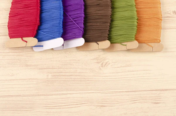 Colorful stacking cotton yarn wool on wooden background — Stock Photo, Image