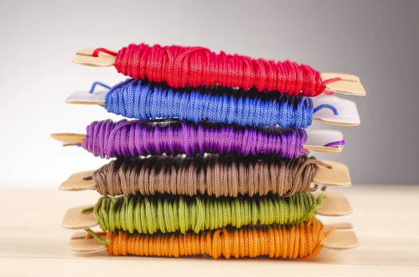 Colorful stacking cotton yarn wool over beautiful reverberation gradient background. — Stock Photo, Image