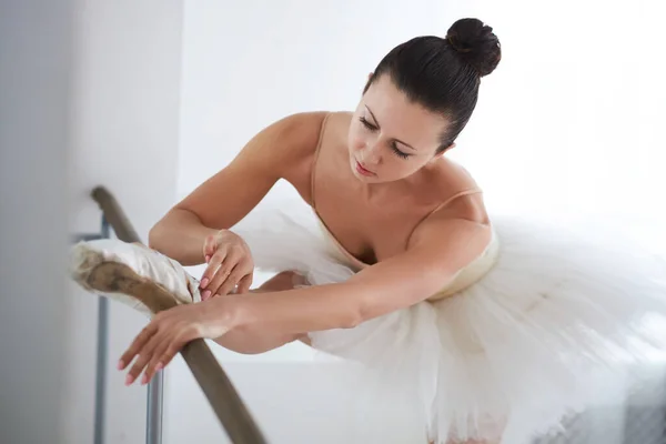 Beautiful ballerina stretching leg. Studio shot. — Stock Photo, Image