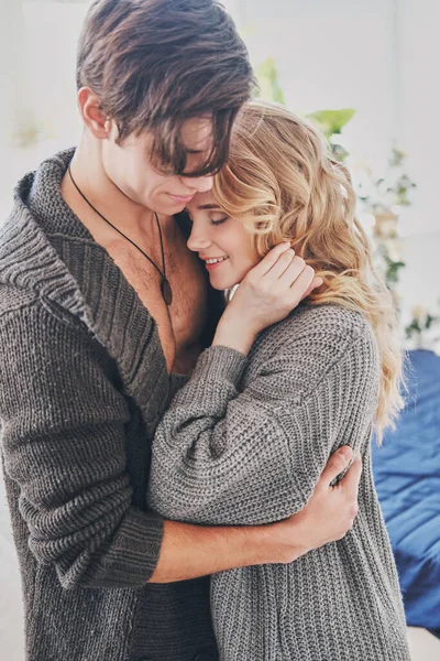 Attractive man and woman in the bedroom together cuddling cute — Stock Photo, Image