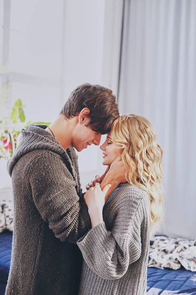 Attractive man and woman in the bedroom together cuddling cute — Stock Photo, Image