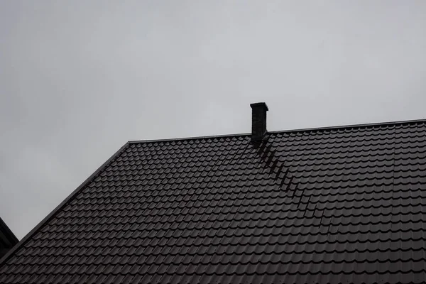 Roof with a chimney in cloudy weather — Stock Photo, Image