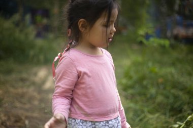 Ormanda 4 yaşında bir kız. Asyalı görünümlü küçük kız