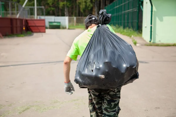 Garbage collection in plastic bags. Environmental protection.