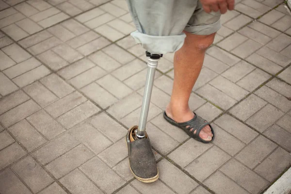 Metal prosthetic leg. Simple prosthetics for a man\'s leg.