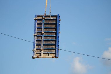 İnşaat alanında çalışıyorum. Bir vinçle duvarı hareket ettiriyor.. 