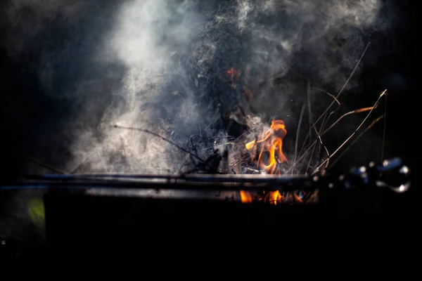 Smoke in natural light. Puffs of smoke over the barbecue.