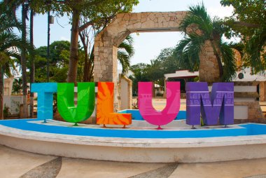 TULUM, MEXICO: Outdoor view of huge colorful letters of Tulum at the enter of Mayan Ruins of Tulum in Meixco. clipart