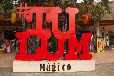 TULUM, MEXICO: Red sign of Tulum. Outdoor view of huge colorful letters of Tulum at the enter of Mayan Ruins of Tulum in Meixco, Yucatan. clipart
