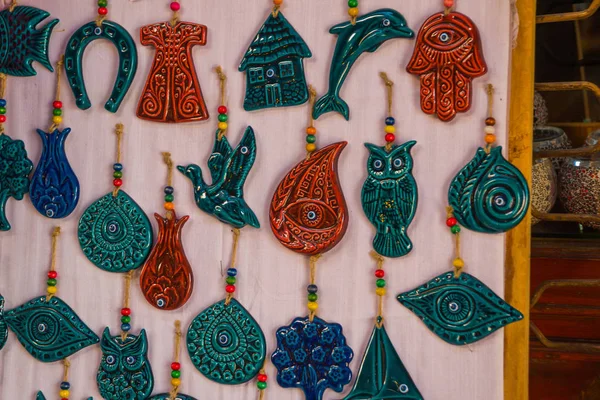 Colorful Souvenirs for tourists: animals, birds, horseshoe, house, eye owl ship tree Turkey Ankara Bazaar
