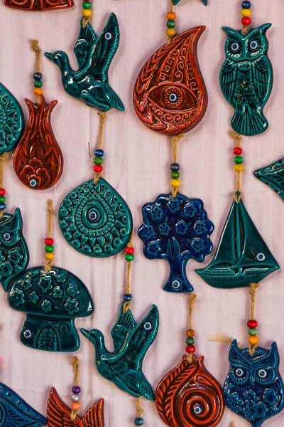 Colorful Souvenirs for tourists: animals, birds, horseshoe, house, eye owl ship tree Turkey Ankara Bazaar