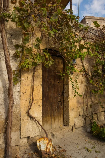 Goreme, Cappadocia, Turkey: Old wooden door. Famous cave hotels in Goreme. Landscape with view of cave houses