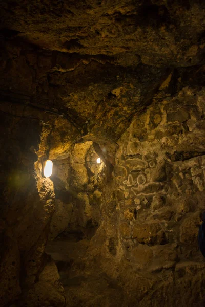 The Derinkuyu underground city is an ancient multi-level cave city in Cappadocia, Turkey. Stone used as a door in the old underground city. Green tour