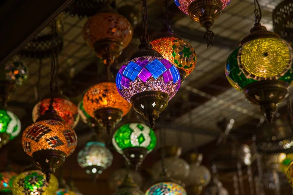 Turkish Bazaar, sale in the market - Souvenirs for tourists. Traditional bright decorative hanging Turkish lights and colourful light lamps with vivid colours in Turkey.