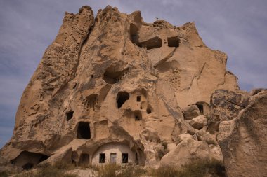 Uchisar, Cappadocia, Anatolia: The fortress Urchisar Castle in Cappadocia located on the highest point in the region. Houses are built into the hillside. clipart