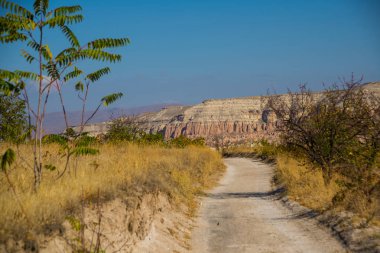 Güllüdere vadisine yol açar. Güzel dağ içinde Cavuşin townscape Göreme Milli Parkı, Aktepe Hill, Kapadokya, Türkiye ile Gül Vadisi.