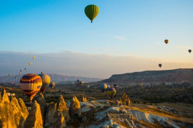 Cappadocia, Göreme, Anadolu, Turkey: Doğal canlı görünümü Kapadokya Vadisi'nin gündoğumu ışınları içinde balon uçuş. Dawn vadilerde güzel. Turistler için en sevdiğiniz eğlencelerin.