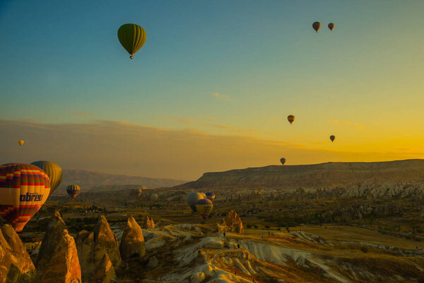 Travel to Goreme, Cappadocia, Turkey. Hot air balloons landing in a mountain Cappadocia Goreme National Park Turkey. Early morning - entertainment for tourists