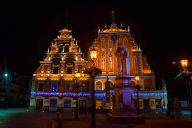 House Blackheads Town Hall Meydanı ve gece gökyüzü arka plan karşı eski şehrin tarihi merkezine katedralde spire. Riga, Letonya.