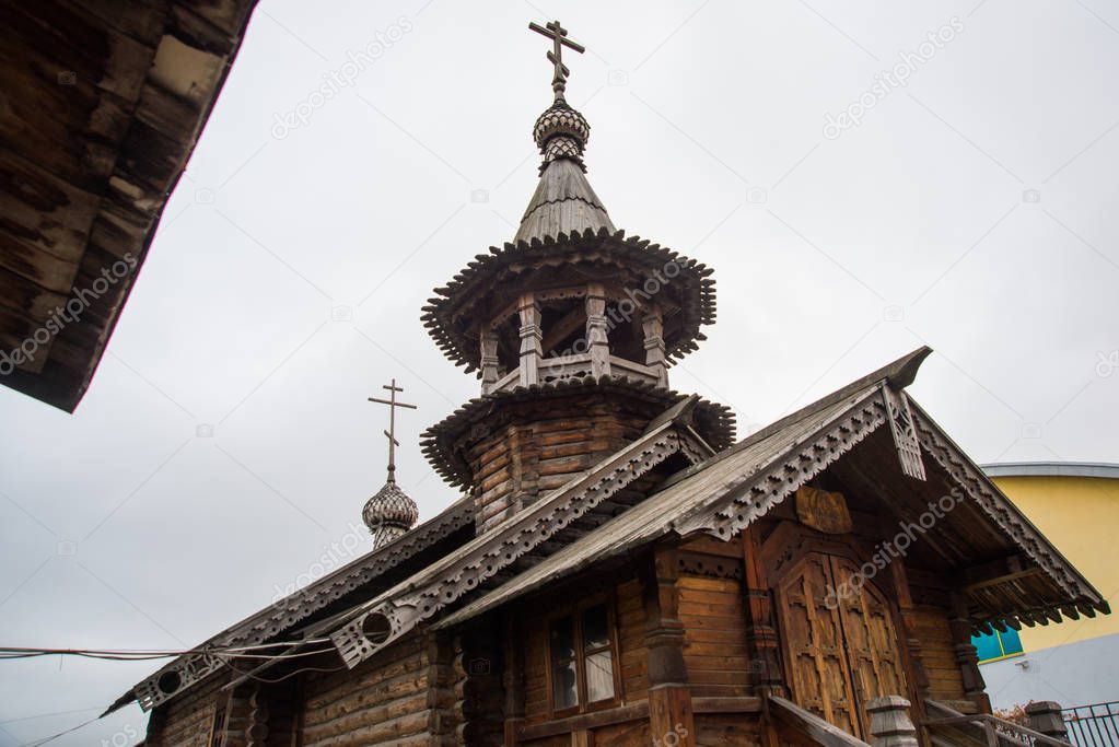 SAINT-PETERSBURG, RUSSIA: Wooden chapel with a bell tower and carved porch at the church of the Holy St. Seraphim Vyritsky. Beautiful old temple in the sky with