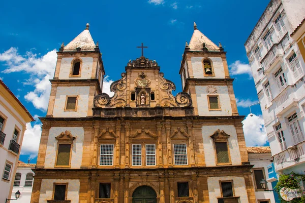 Brillante vista de Pelourinho en Salvador, Brasil, dominado por la gran cruz de piedra cristiana colonial Cruzeiro de Sao Francisco en el Pra a Anchieta — Foto de Stock