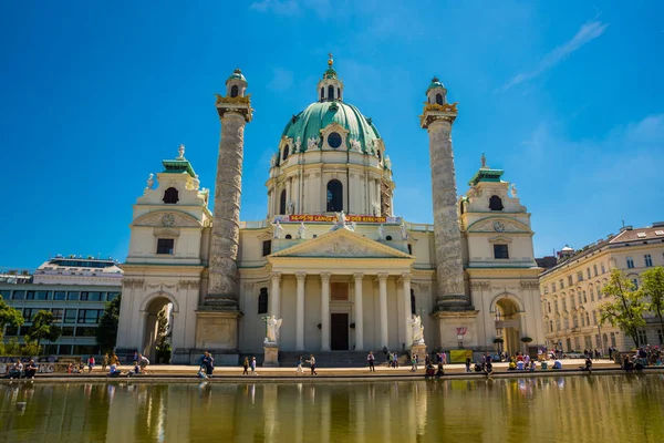 Viyana'daki Karlsplatz'daki St. Charles Kilisesi'nin manzarası. Bulanık bulutlar ve parlak su ile uzun pozlama tekniği