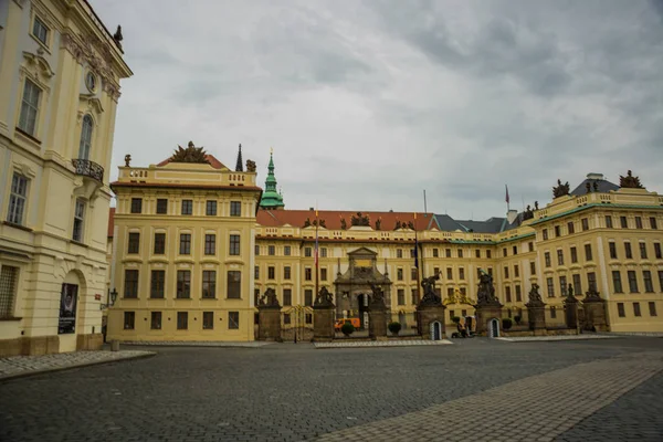 Praga, República Checa: Guardias en la Batalla de Titanes estatuas en la puerta del Primer Patio en el Castillo de Hrad con el Palacio de los Arzobispos detrás en Praga — Foto de Stock