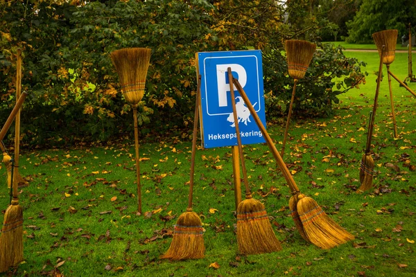 Magic broom witches stand in the Park for scenery. Humorous Parking for brooms. Egeskov Castle, Denmark