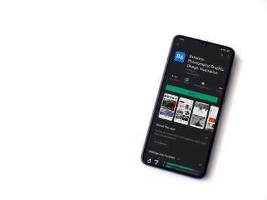 Lod, Israel - 8 Temmuz 2020: Adobe Behance uygulaması oyun mağazası sayfası beyaz arkaplanda izole edilmiş siyah bir cep telefonu ekranında. Üst görünüm düzlüğü kopyalama alanı ile yatıyordu. 